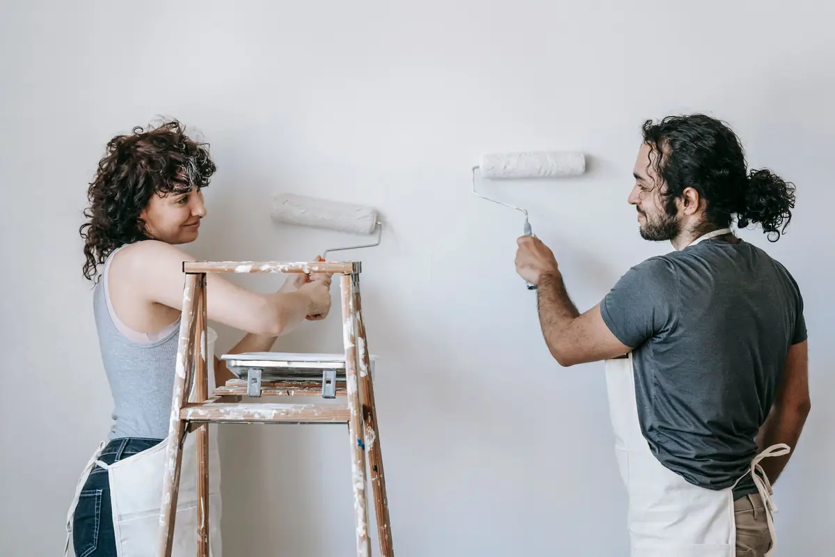 People painting a wall together — painting help in Wichita